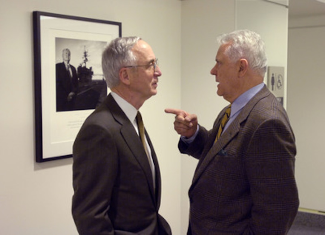 Photographer Nick DelCalzo (right) talks to Deputy Secretary of Defense Gordon England about his portrait of Vice Adm. James Stockdale after a ceremony opening the Visions of Valor display in the Pentagon on Feb. 3, 2006. England hosted the ceremony and was joined by President of the Congressional Medal of Honor Society Gary Littrell and Tri-West Healthcare Alliance President and CEO David McIntyre. Tri-West Healthcare Alliance commissioned two sets of the photographs by DelCalzo that depict 116 of the recipients of the Congressional Medal of Honor. One set was donated for permanent display in the Pentagon and the other will comprise a traveling exhibit to be shown nationally. 