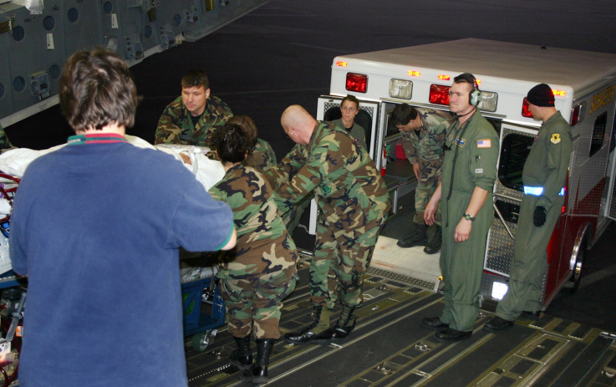 LOS ANGELES (AFPN) -- The Wilford Hall Medical Center team arrives from Hawaii with 7-year-old Meaghan Ababa, and carefully offloads her from the C-17 Globemaster III into a waiting ambulance. She was on her way to the Children's Hospital in Los Angeles where doctors were standing by to perform a heart transplant if needed. (U.S. Air Force photo by Master Sgt. Kimberly Spencer)