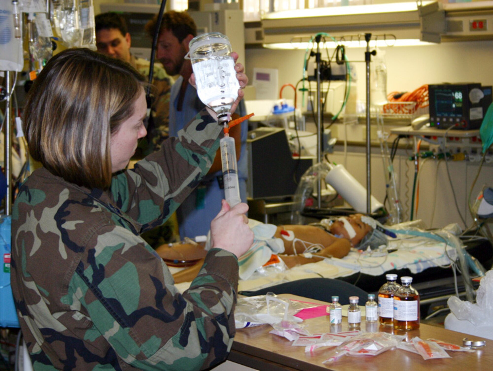 HONOLULU (AFPN) -- Capt. Jeannette Gonzalez prepares additives for the blood used in the mobile extracorporeal membrane oxygenation, or ECMO, machine. The levels of calcium, sodium and other chemicals must duplicate the blood Meaghan Ababa is currently receiving to minimize negative reactions during transfer to the Children's Hospital in Los Angeles. (U.S. Air Force photo by Master Sgt. Kimberly Spencer)