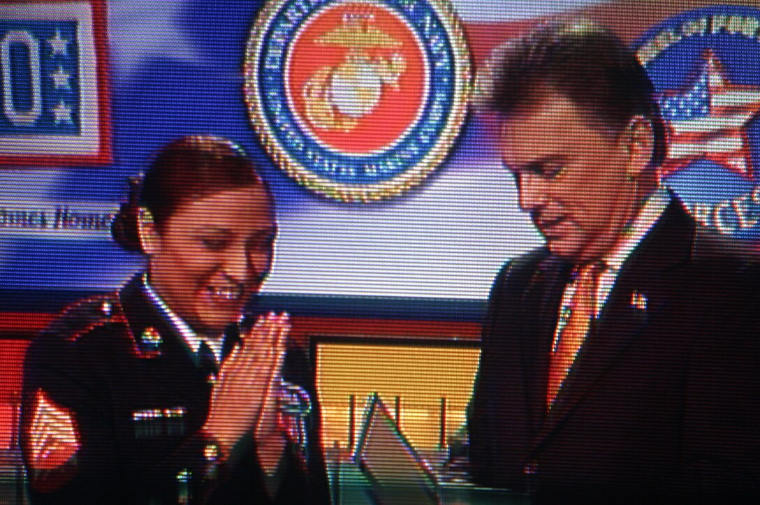 Sgt. Diana I. Aragon, intelligence analyst with Combat and Logistics Regiment 1, 1st Marine Logistics Group, rubs her hands together in excitement as ?Wheel of Fortune? host Pat Sajak opens an envelope during a taping of the popular game show at Sony Entertainment Studios in Los Angeles Feb. 8. The 21-year-old from Milwaukee was among 15 servicemembers who appeared on the show when it hosted ?Wheel Salutes the Armed Forces,? which is scheduled to air the week of April 3.