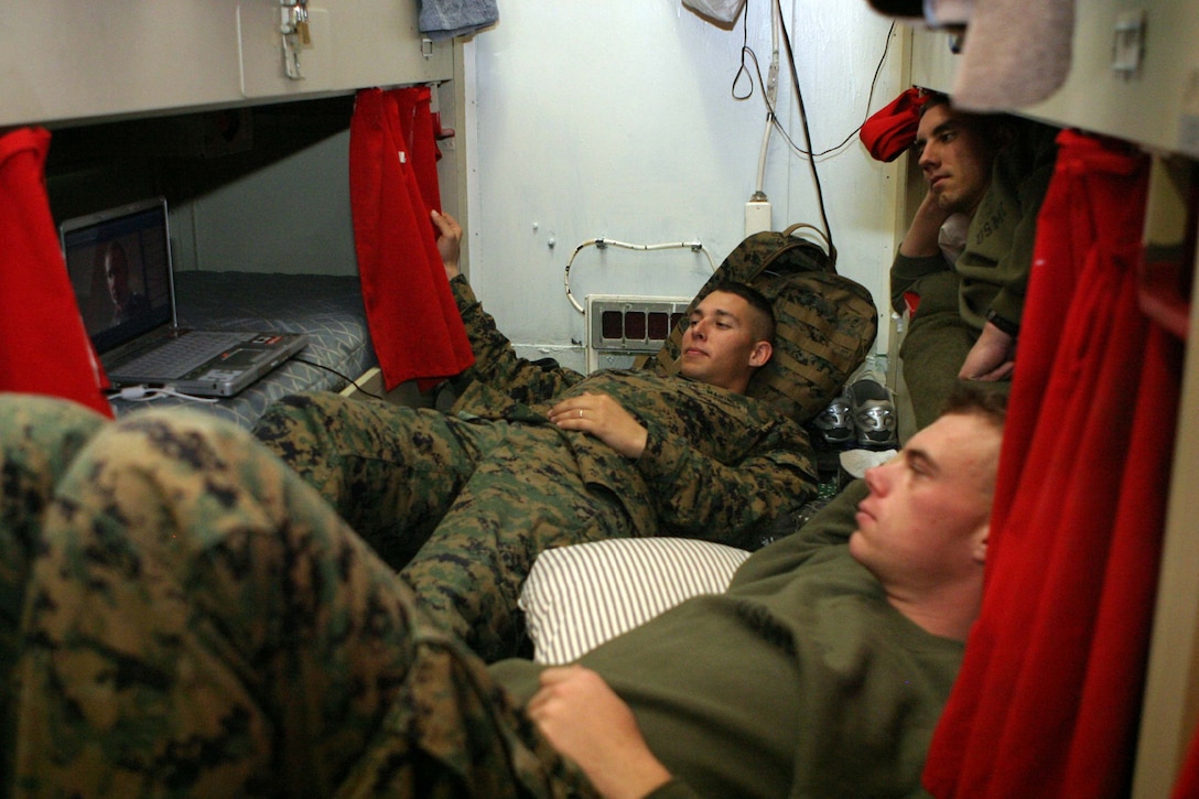 Corporal. Jacob D. Newman, Lawrence R. Wrenn and Chad M. Snyder, each with MEU Service Support Group 24, spending time watching movies between operations during Expeditionary Strike Group/MEU Integration Training aboard the USS Iwo Jima Feb. 8.  Marines have found several ways to stay motivated while serving while at sea by playing cards, basketball and participating in physical training.