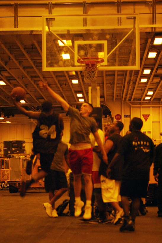 Marines and Sailors aboard the USS Iwo Jima during Expeditionary Strike Group/MEU Integration Training play basketball during their off time.  Marines have found that killing time aboard ship can be done by playing cards, competing in sports or reading books.