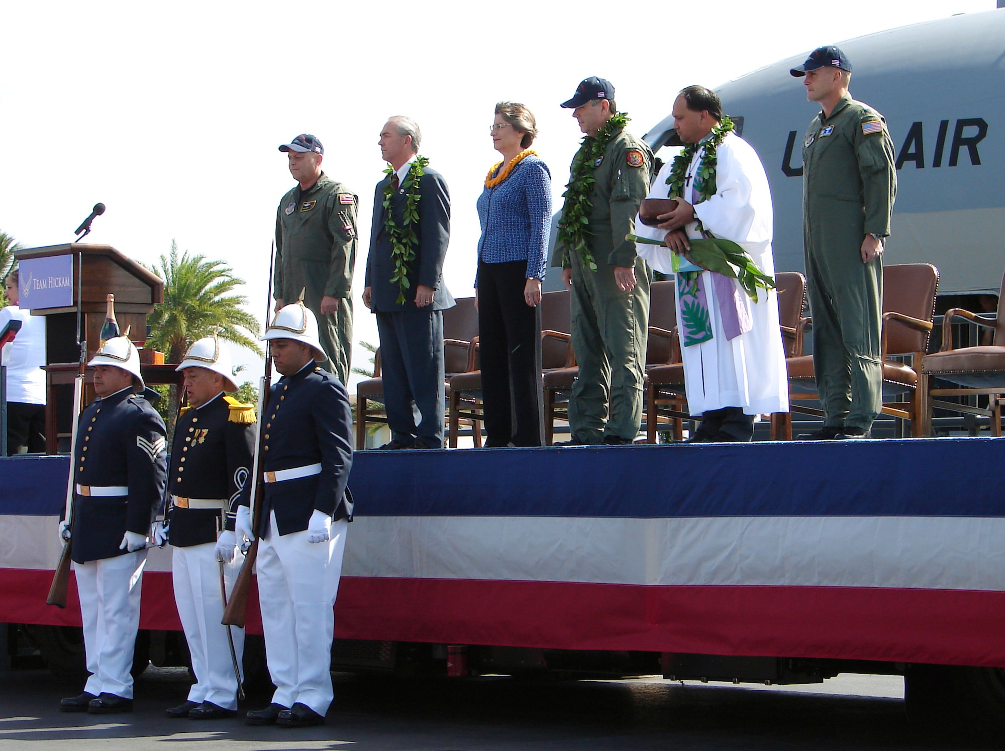 HICKAM AIR FORCE BASE, Hawaii (AFPN) -- (From left) Brig. Gen. Peter S. Pawling, commander of the 154th Wing, Hawaii Air National Guard; Ron Marcotte the vice president and general manager for global mobility at the Boeing Company; Gov. Linda Lingle; Gen. Paul V. Hester; Kahu Kordell Kekoa; and Col. William J. Changose, commander of the 15th Airlift Wing, observe the "posting of the colors" during the welcoming ceremony for PACAF's first C-17 Globemaster III. (U.S. Air Force photos by Maj. Brad Jessmer)