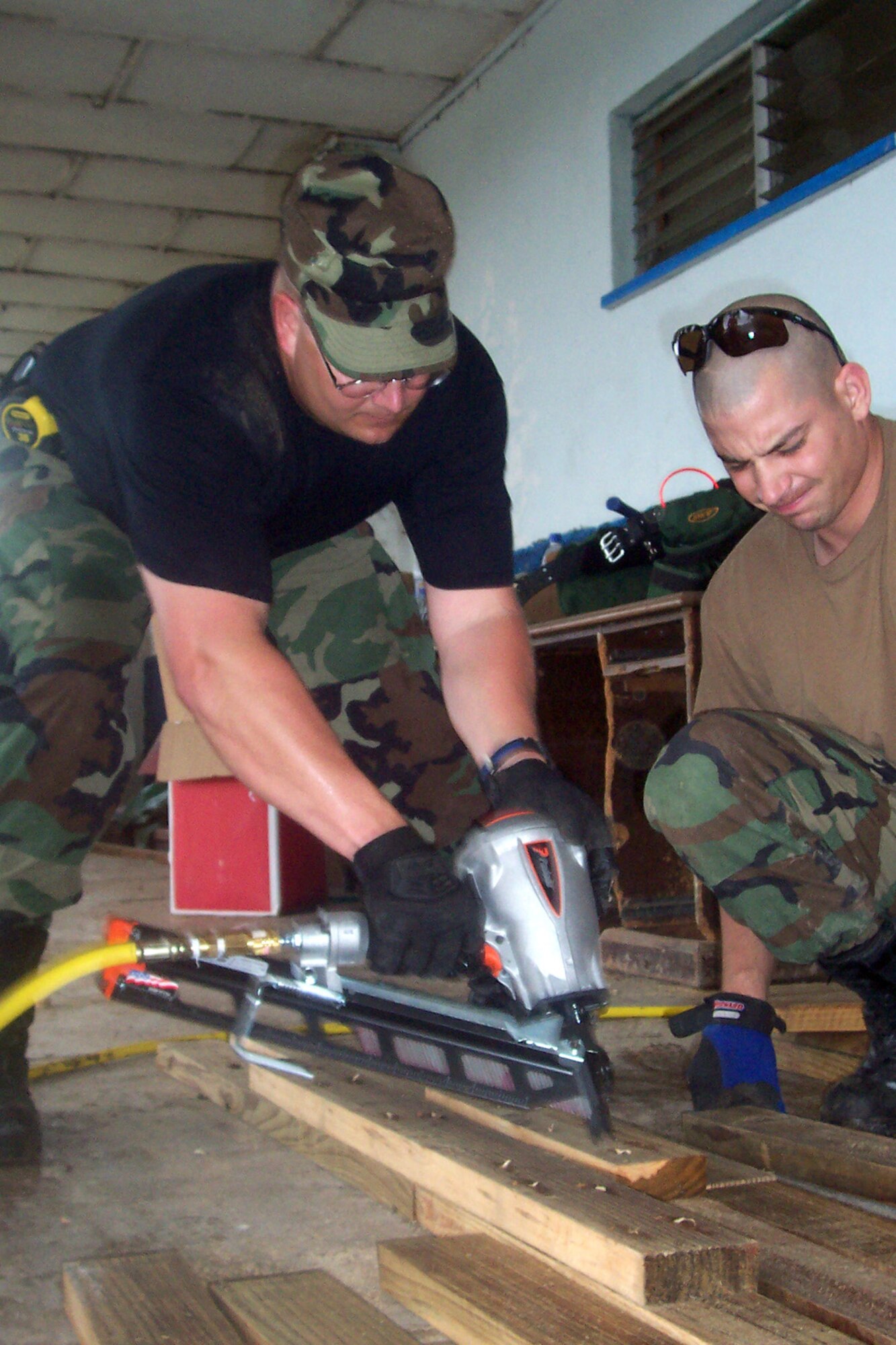 LA CEIBA, Honduras (AFPN) -- Tech. Sgt. Ivan Young and Staff Sgt. Robert Sheipline were among the first to help put together the tents that "New Horizons 2006 -- Honduras" participants will live in during the four-month long training exercise. (U.S. Air Force photo by Staff Sgt. Beth Orlen) 