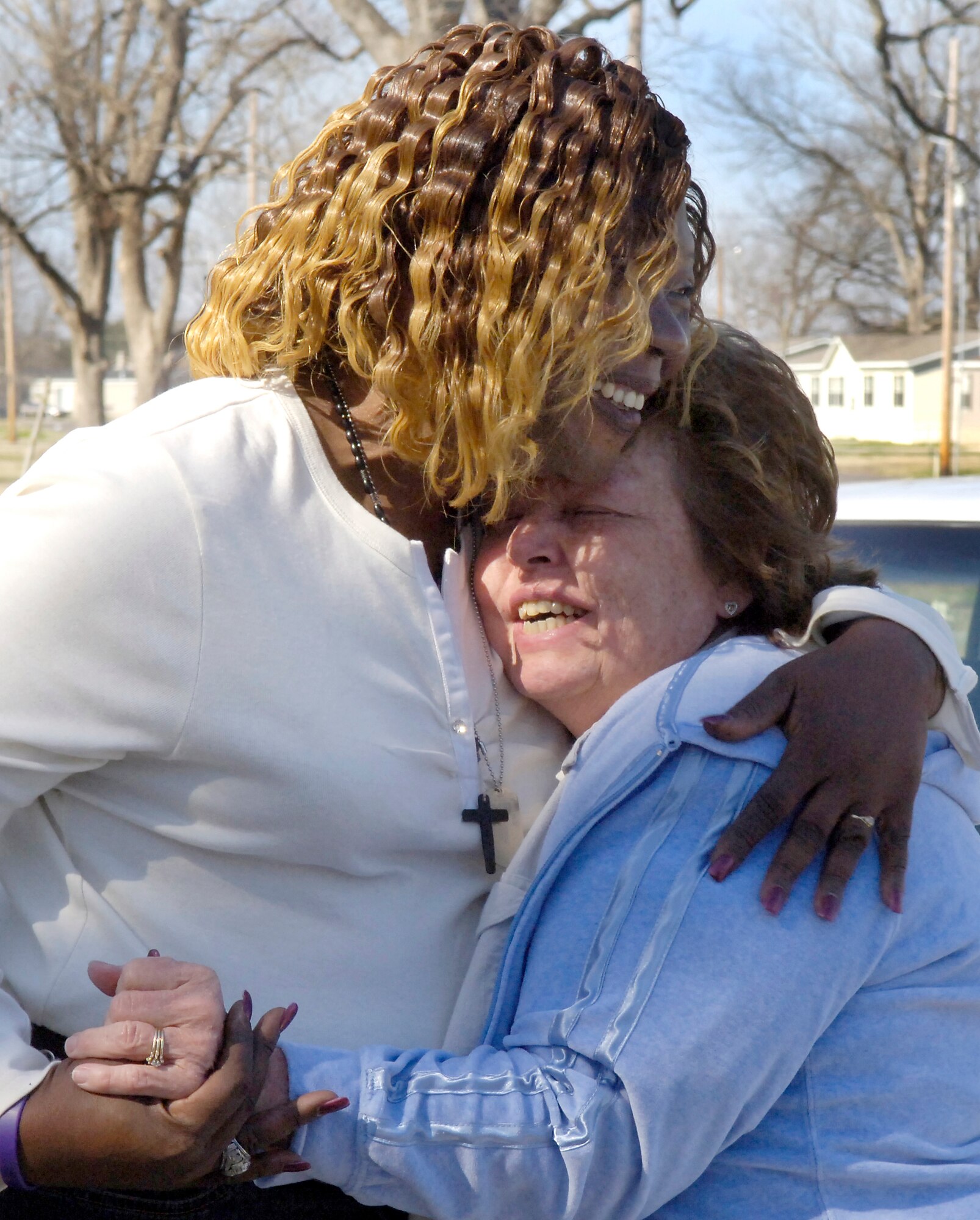 BARKSDALE AIR FORCE BASE, La. (AFPN) -- Denise Godbolt (left), mother of late Army Sgt. Lee Myles Godbolt, hugs Susan Jarrett for the two new shadow boxes presented to her Feb 8.  Retired Tech. Sgt. Mike Jarrett, woodcraft manager here, replaced the original shadow boxes that were damaged in Hurricane Katrina. (U.S. Air Force photo by Senior Airman Brian Ferguson)