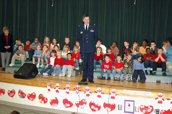 Chaplain (Maj.) John Painter, a reservist assigned to the 315th Airlift Wing at Charleston AFB, S.C., talks to first-grade children at Sangree Elementary School in Summerville, S.C. as the children prepare to present "Quilts of Valor" to the Chaplain.  Chaplain Painter accepted two quilts on behalf of his civilian employer the Ralph H. Johnson VA Medical Center and two quilts that will be delivered by the 315th Airlift Wing to a regional hospital in Germany. (Photo by Tech. Sgt. Mark Kleber)
