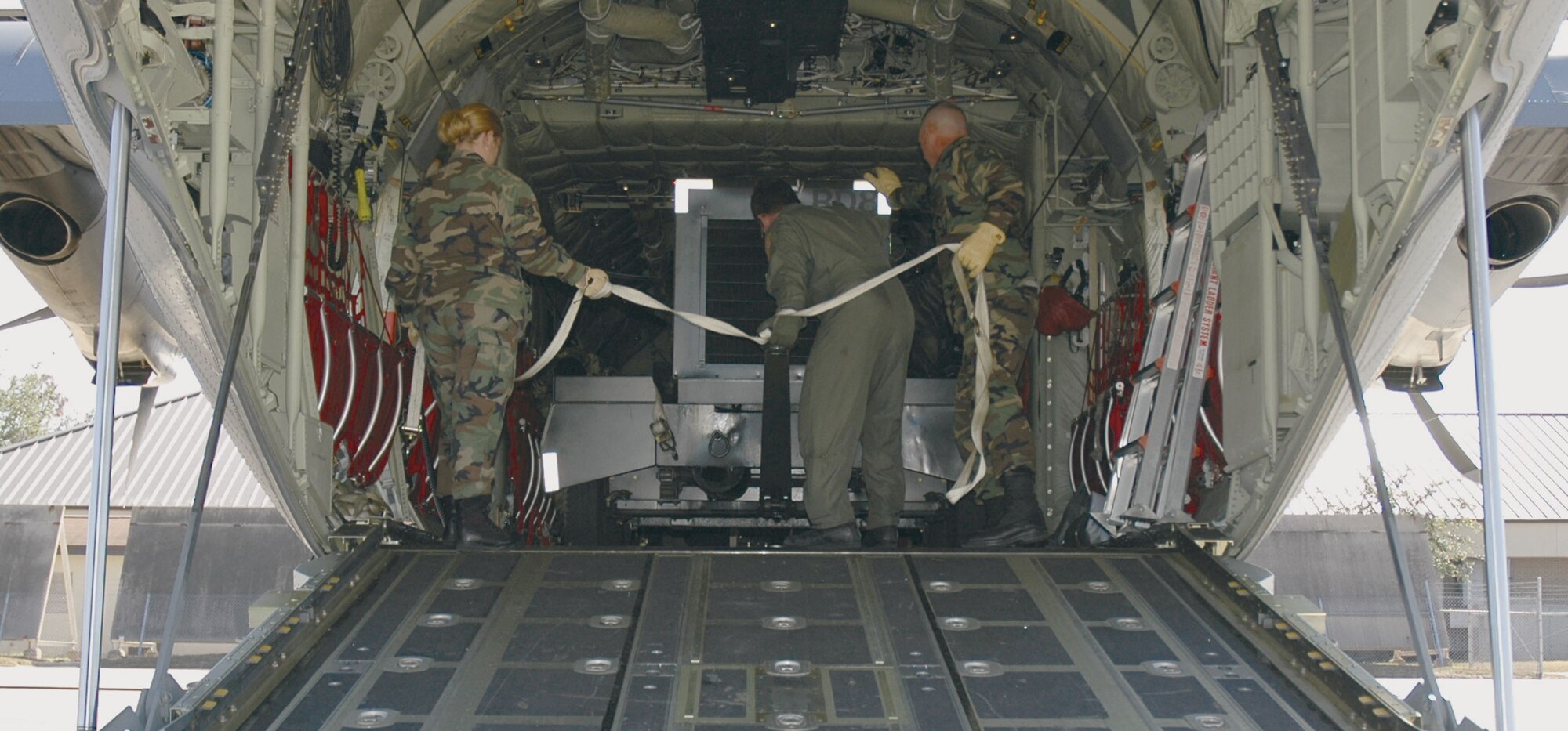 Many aerial porters came right back to work at Keesler after Katrina. These APS folks are unloading a generator when the 403rd Wing's aircraft returned in November.

