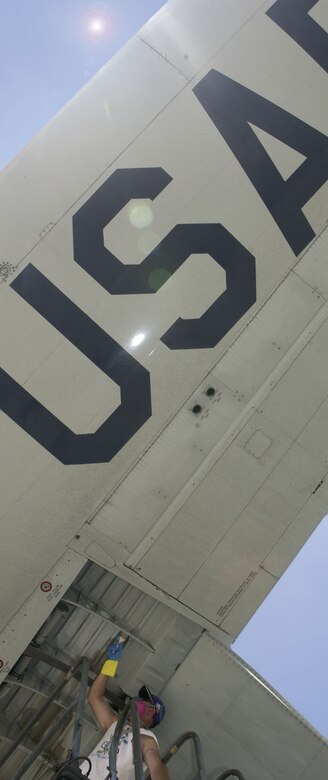 Mr. Robert Clancy applies some touch up paint to a wing of a 403rd C-130J. Clancy, a master sergeant and air reserve technician, has been with the unit for more than18 years.