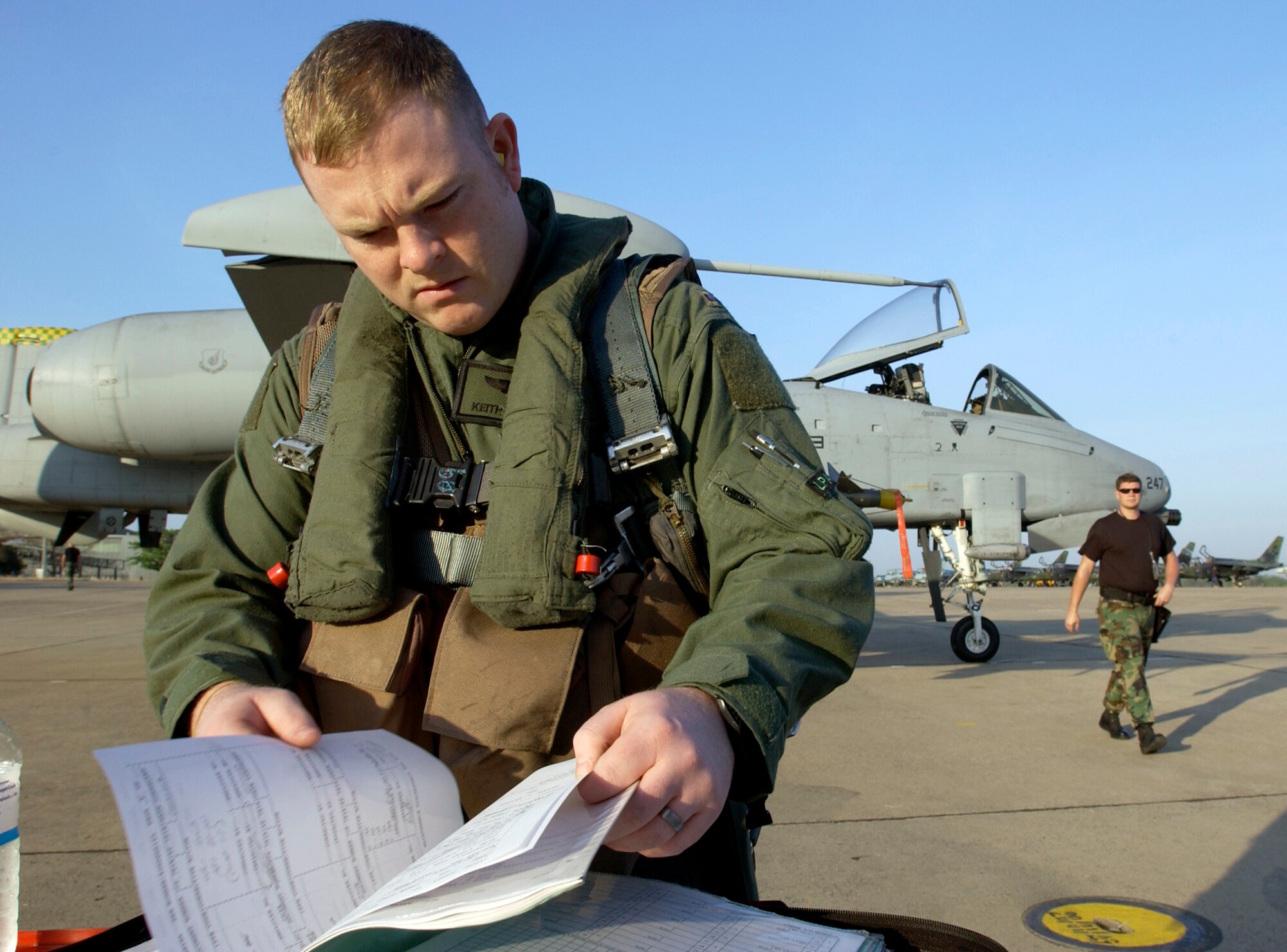 KORAT ROYAL AIR FORCE BASE, Thailand (AFPN) -- First Lt. Keith Bonser checks maintenance forms before an exercise Cope Tiger '06 mission here Feb. 8. Lieutenant Bonser is an A-10 Thunderbolt II pilot from the 25th Fighter Squadron at Osan Air Base, South Korea.  (U.S. Air Force photo by Tech. Sgt. Keith Brown) 

