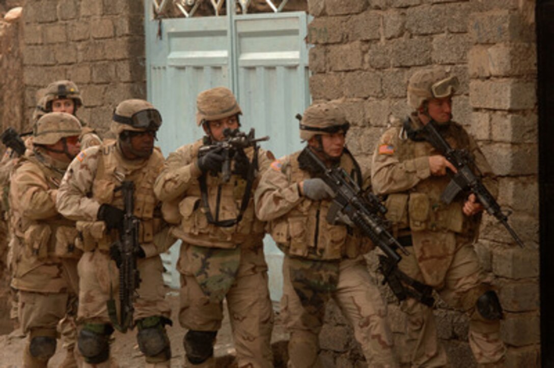 Soldiers line up against a wall as they prepare to enter a building during a combat patrol in Tall Afar, Iraq, on Feb. 7, 2006. These soldiers are attached to the U.S. Army's 3rd Armored Cavalry Regiment. 