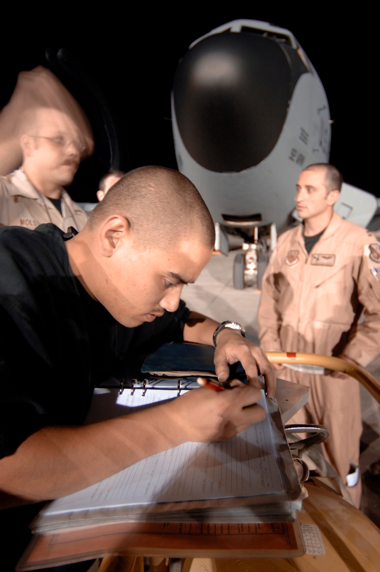 SOUTHWEST ASIA (AFPN) -- Senior Airman Adam Pham updates a KC-135 Stratotanker maintenance logbook.  Airman Pham is deployed with the 379th Expeditionary Maintenance Squadron. (U.S. Air Force photo by Master Sgt. Lance Cheung)