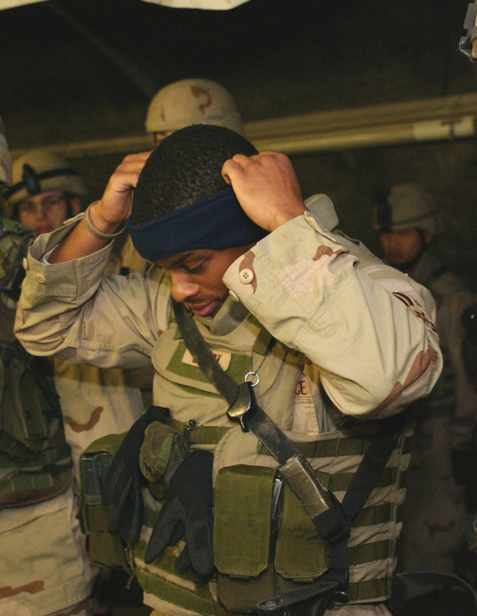 060129-F-6878W-008 
KIRKUK AIR BASE, Iraq (AFPN) -- Airman 1st Class Steven Cherry puts on a donated headband with built-in ear protectors before going out on patrol. The headbands were donated to 506th Expeditionary Security Forces Squadron by family members of Tech. Sgt. Max Quitiquit from the 506th Expeditionary Logistic Readiness Squadron. (U.S. Air Force photo by Airman 1st Class JoAnn White) 