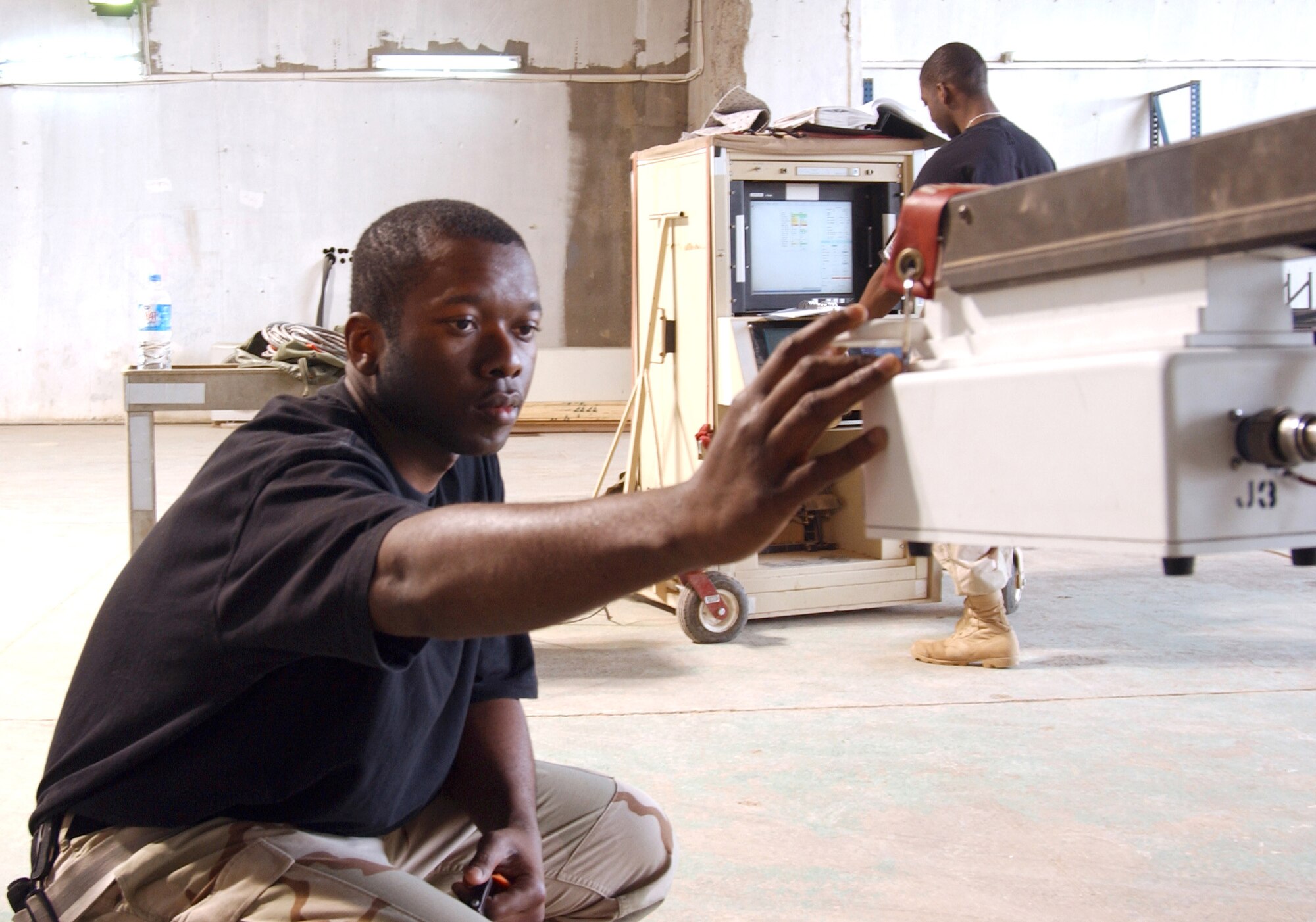 BALAD AIR BASE, Iraq (AFPN) -- Staff Sgts. Jawann Wilson (foreground) and Bryan Larry perform a weapon system confidence check on an MQ-1 Predator unmanned aerial vehicle. The Airmen -- weapons load crew members -- are with the 332nd Expeditionary Aircraft Maintenance Squadron. (U.S. Air Force photo by Staff Sgt. Robert Wollenberg) 