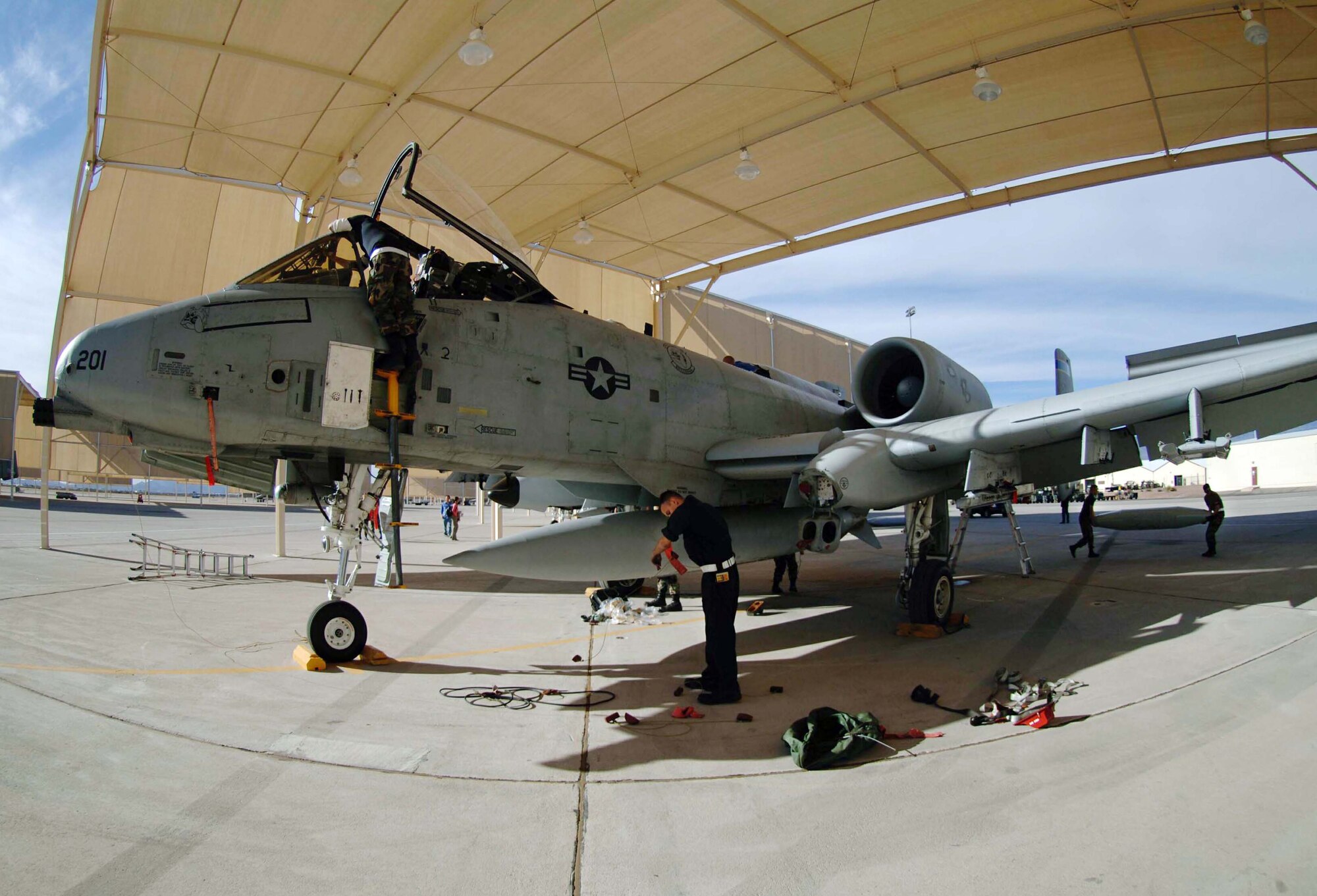 DAVIS-MONTHAN AIR FORCE BASE, Ariz. (AFPN) -- Crew chiefs with the 355th Aircraft Maintenance Squadron inspect an A-10 Thunderbolt II upon its return here Feb. 8. A-10s from the 354th Fighter Squadron were deployed to Bagram Air Base, Afghanistan, in support of Operation Enduring Freedom.  (U.S. Air Force photo by Airman 1st Class Christina D. Ponte)