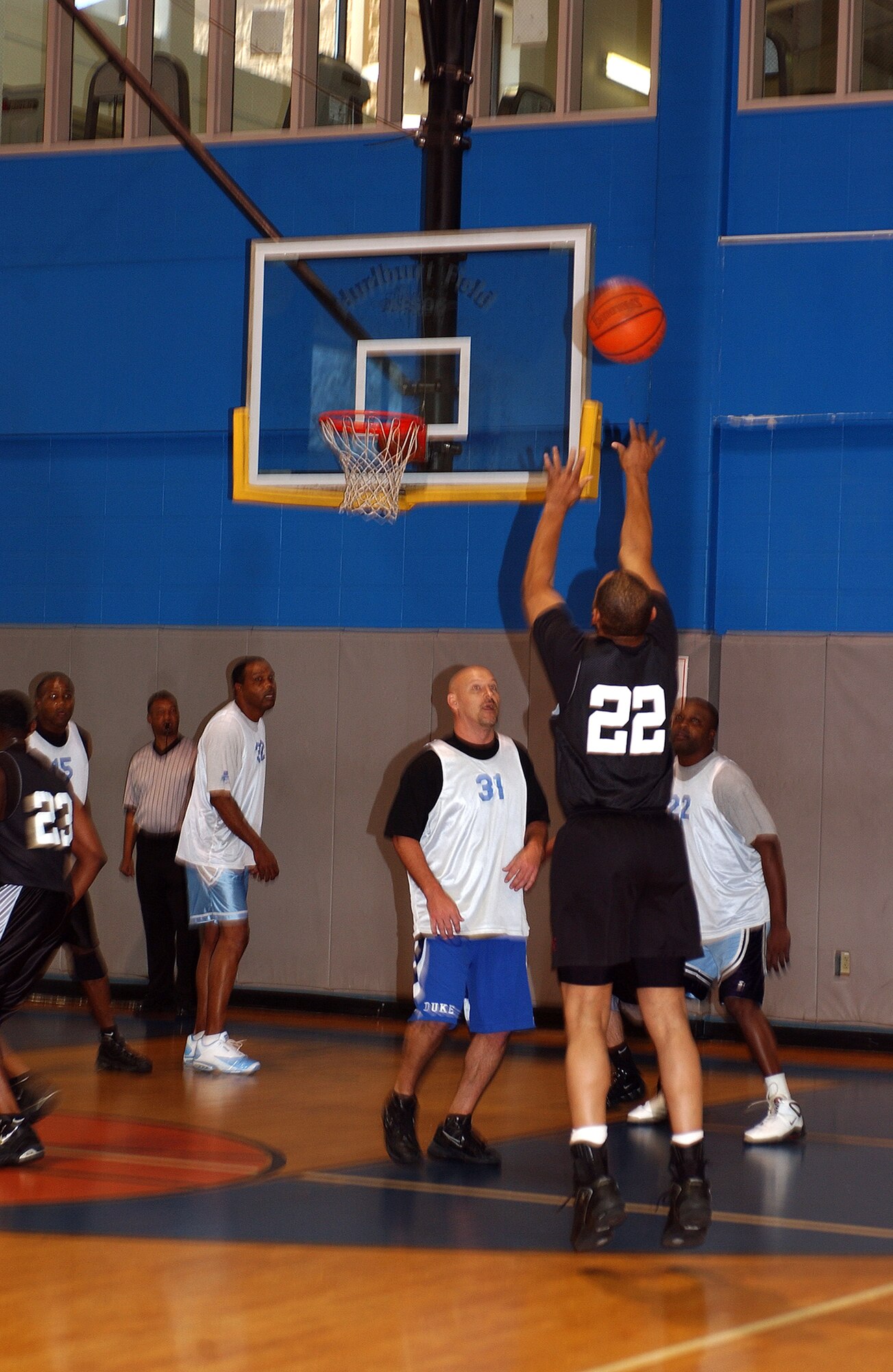 Lynn Lawrence, 16th Medical Group team, shoots, while Richard Johnston (left) and Kenneth Hansford, Air Force Special Operations Command, defend during the over-30 basketball play-off game Tuesday in the Aderholt Fitness Center.