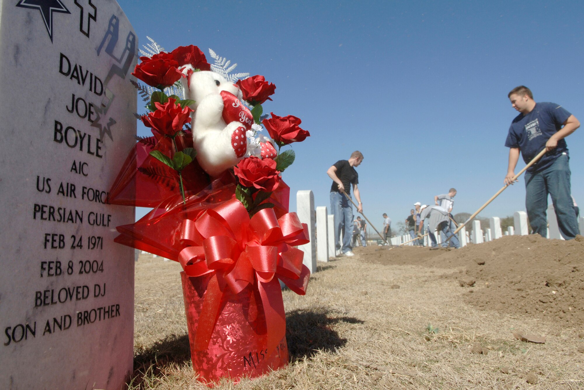 FORT SAM HOUSTON, Texas (AFPN) -- Airmen volunteers landscape and straighten headstones at Fort Sam Houston National Cemetery Feb. 8.  The Airmen are assigned to the Cryptologic Systems Group at Lackland Air Force Base, Texas. (U.S. Air Force photo by Master Sgt. Jack Braden)
