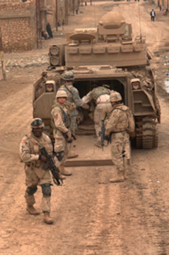 Soldiers from the Armyís 3rd Armored Cavalry Regiment load into an M2 Bradley infantry fighting vehicle as they conduct a combat patrol in the streets of Tall Afar, Iraq, on Feb. 6, 2006. 