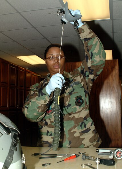 WHITEMAN AIR FORCE BASE, Mo. -- Staff Sgt. Lisa Adamson, life support specialist, 303rd Fighter Squadron, closely eamines the wires of an oxygen mark assembly during the Febrauary Unit Training Assembly. The 303rd FS is part of the 442nd Fighter Wing, an Air Force Reserve unit based at Whiteman Air Force Base, Mo. (Photo by Staff Sgt. Angela Blazier)