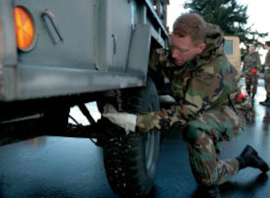 Tech. Sgt. William Burks, a Reservist with the 86th Aerial Port Squadron, performs a foreign object damage check on his vehicle while practicing for the June Operational Readiness Inspection.
