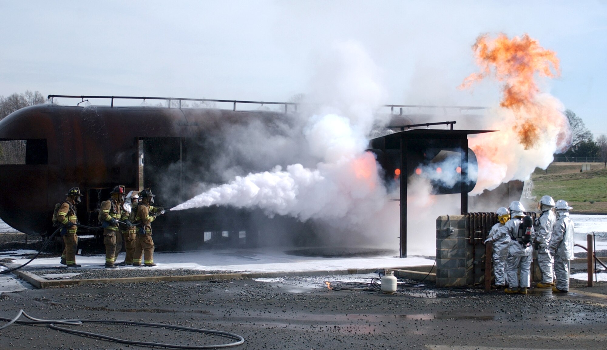 CHARLOTTE, N.C. (AFPN) -- Firefighters from the 916th Air Force Reserve Fire Protection Flight fight a fire during an exercise on a mock fuselage. The 916th, assigned to nearby Seymour Johnson Air Force Base, is performing their annual recertification training. (U.S. Air Force photo by Tech. Sgt. Brian E. Christiansen)