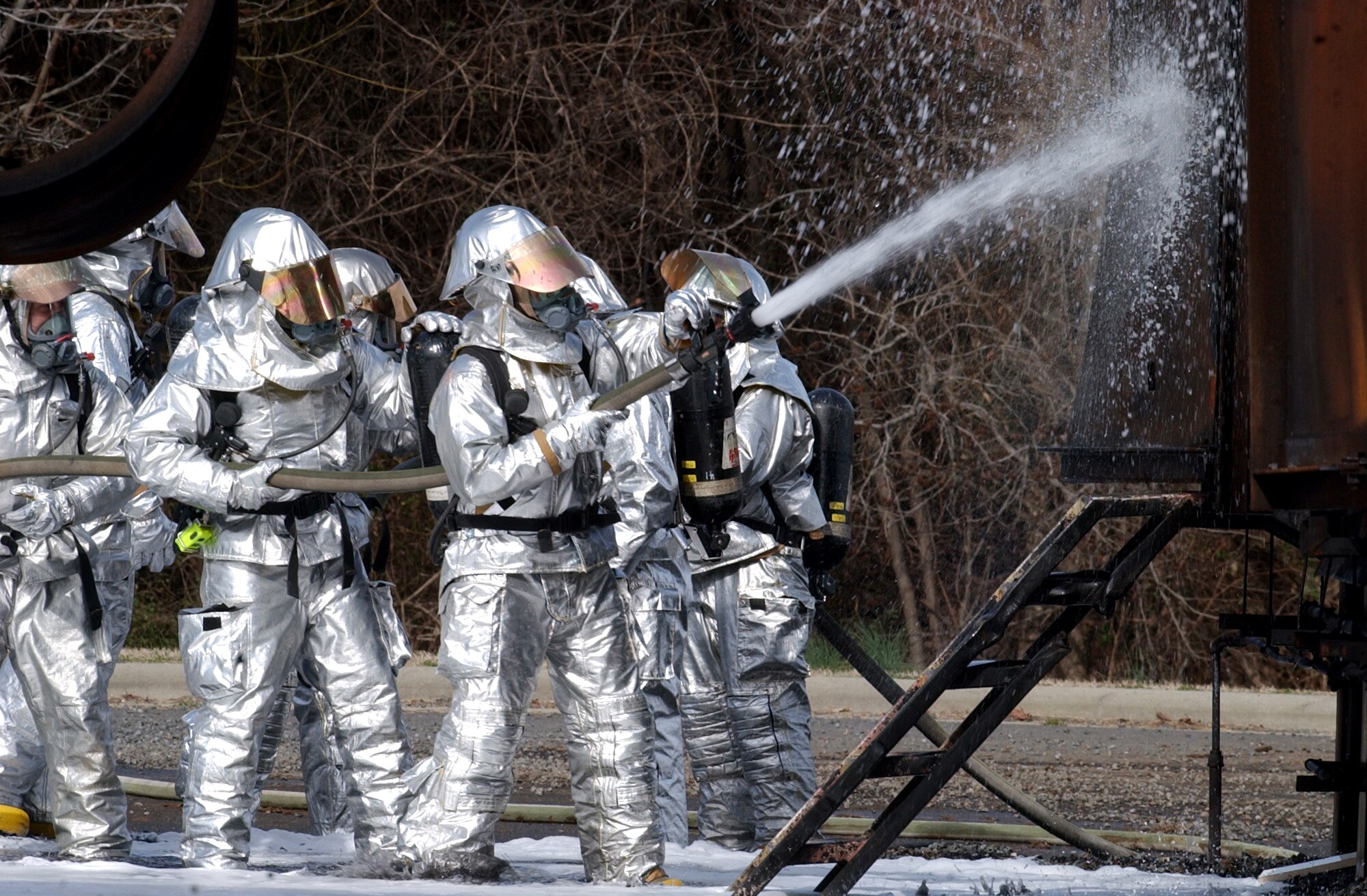 CHARLOTTE, N.C. (AFPN) -- Firefighters with the 916th Air Force Reserve Fire Protection Flight fight a fire during an exercise on a mock fuselage. The 916th, based at nearby Seymour Johnson Air Force Base, is performing their annual recertification course at the aircraft fire training center here. The center is jointly owned and operated by the city of Charlotte and the North Carolina Air National Guard. (U.S. Air Force photo by Tech. Sgt. Brian E. Christiansen)
