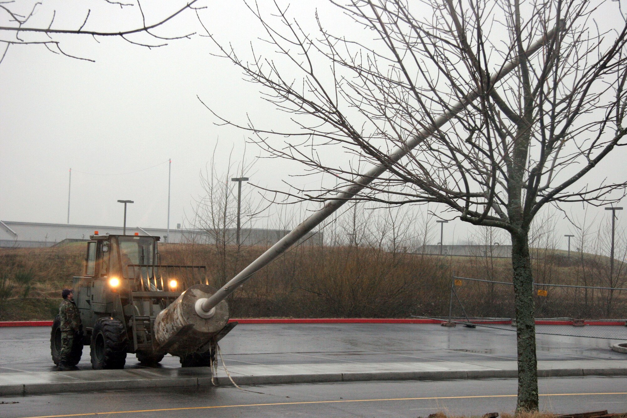 PORTLAND, Ore. (AFPN) -- Guardsmen with the 142nd Fighter Wing move a flagpole from the construction site at the 939th Air Refueling Wing building here. The flagpole, 45 feet long and weighing 11,000 pounds, was moved to the Flathead Indian Reservation, Mont.  During construction, the flagpole had been turned into the Defense Reutilization and Marketing Office here. It was then acquired by the 25-year-old Salish-Kootenai College on the reservation; it will be the first flagpole for the school. (U.S. Air Force photo by Ruby Zarzyczny)