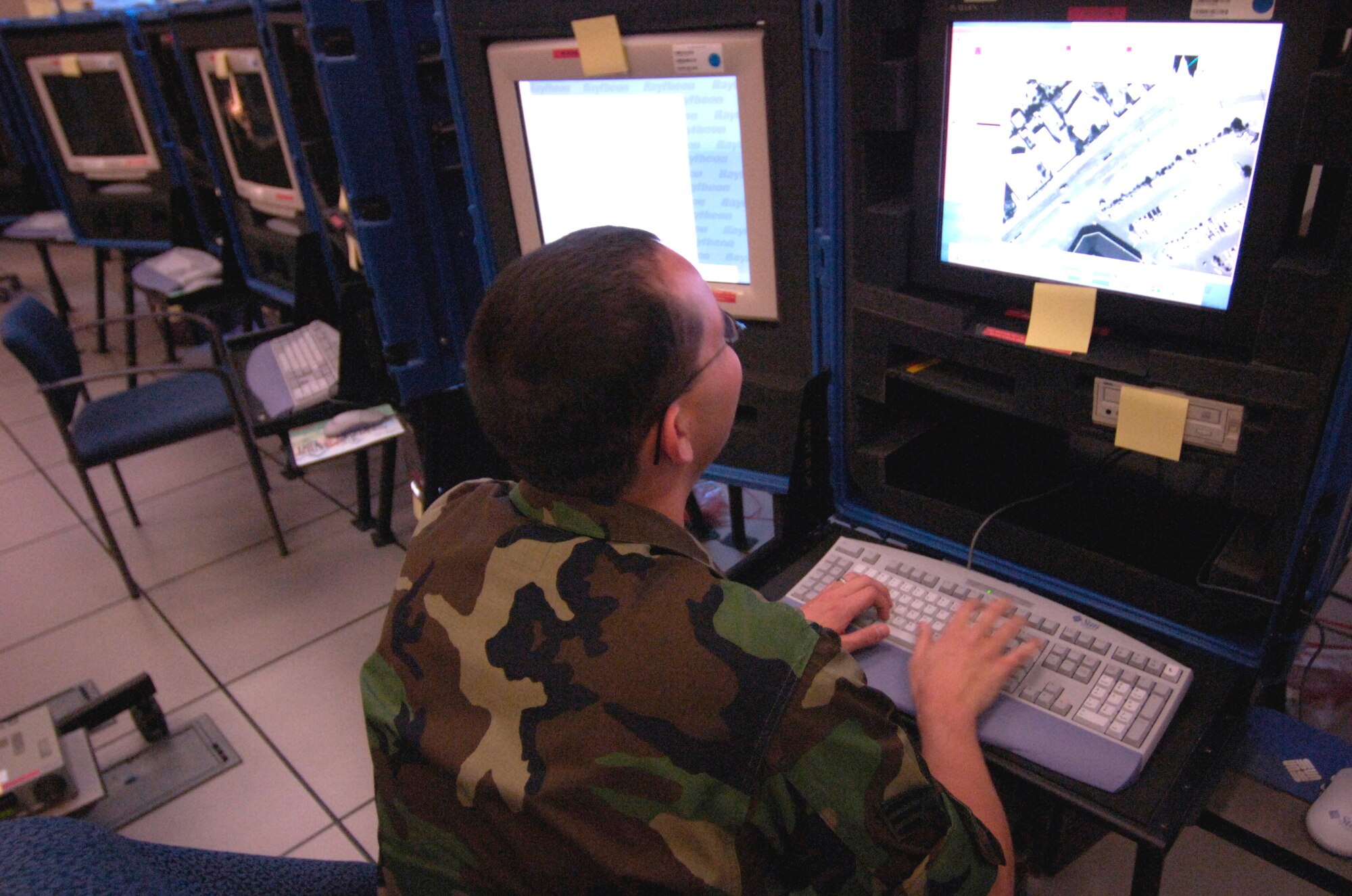 HICKAM AIR FORCE BASE, Hawaii (AFPN) -- Senior Airman Joshua Stimmel looks over imagery during a training mission at a distributed ground stations for the Predator unmanned aerial vehicle. Unmanned aerial vehicles represent a new way of using technology to remotely affect the battlefield. (U.S. Air Force photo by Tech. Sgt. Shane A. Cuomo) 
