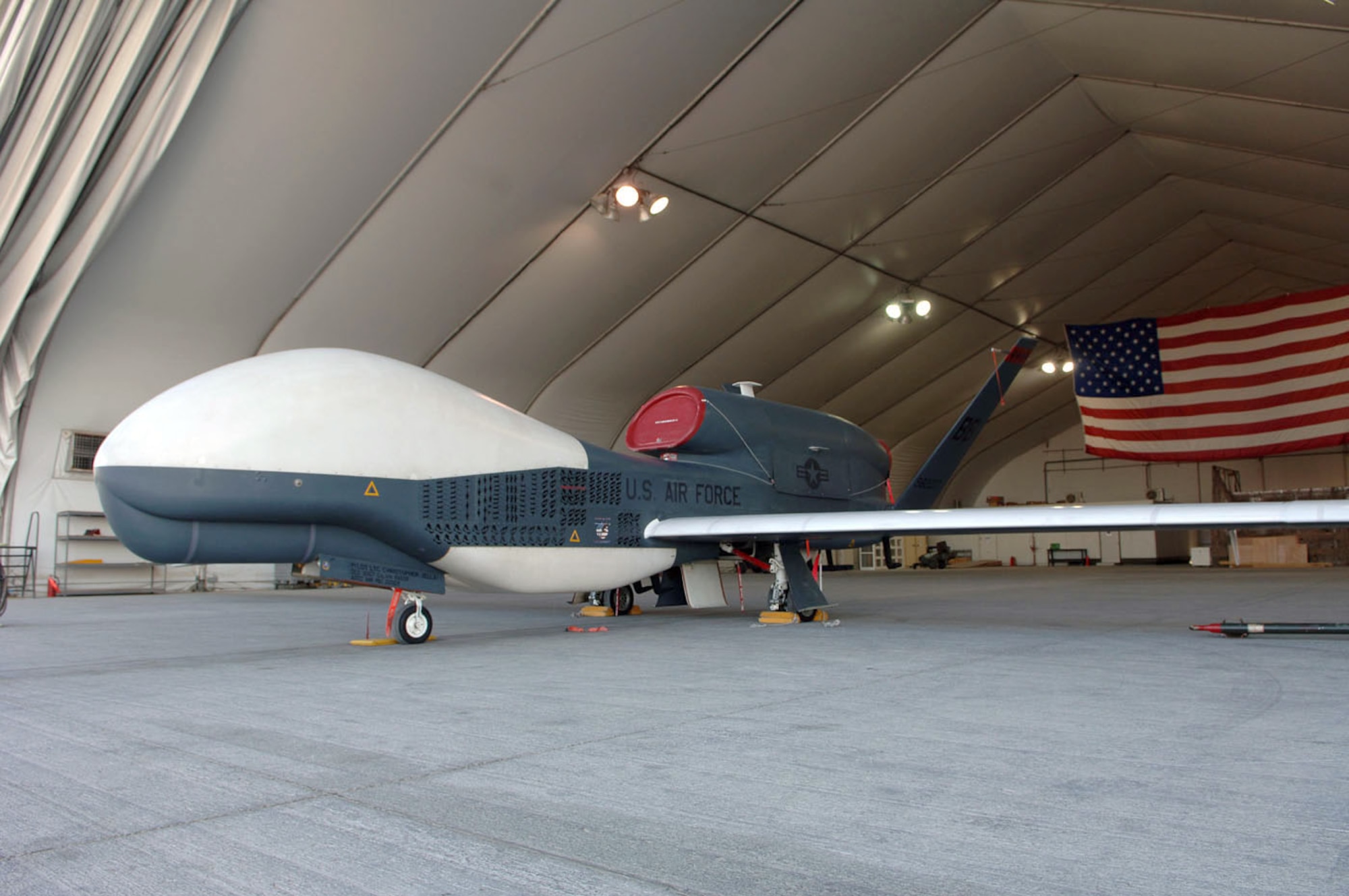 SOUTHWEST ASIA (AFPN) -- Prototype Global Hawk Air Vehicle No. 3 sits ready in its hangar before a voyage halfway around the world to Edwards Air Force Base, Calif. During its four years with the 12th Expeditionary Reconnaissance Squadron the prototype flew nearly 4,250 combat hours in support of the global war on terrorism. (U.S. Air Force photo by Staff Sgt. Christopher J. Matthews) 