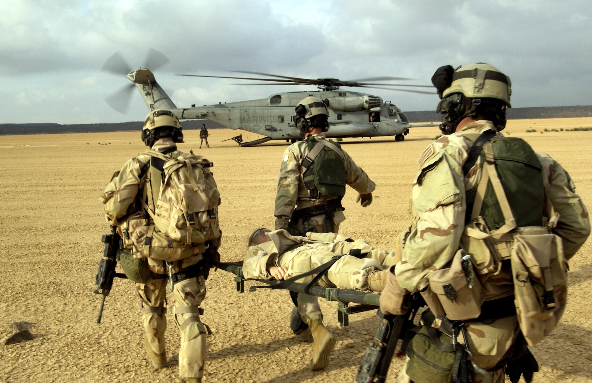 A simulated injured Airman is carried by Air Force pararescuemen toward a Marine CH-53 Super Stallion helicopter during a search and rescue exercise Wednesday, Feb. 8, 2006, at Camp Lemonier, Djibouti, Africa. Administrative control for select active-duty Air Force combat search and rescue assets is transferring from Air Force Special Operations Command to Air Combat Command, the Air Force announced Feb. 27. (U.S. Air Force photo/Staff Sgt. Ricky A. Bloom)