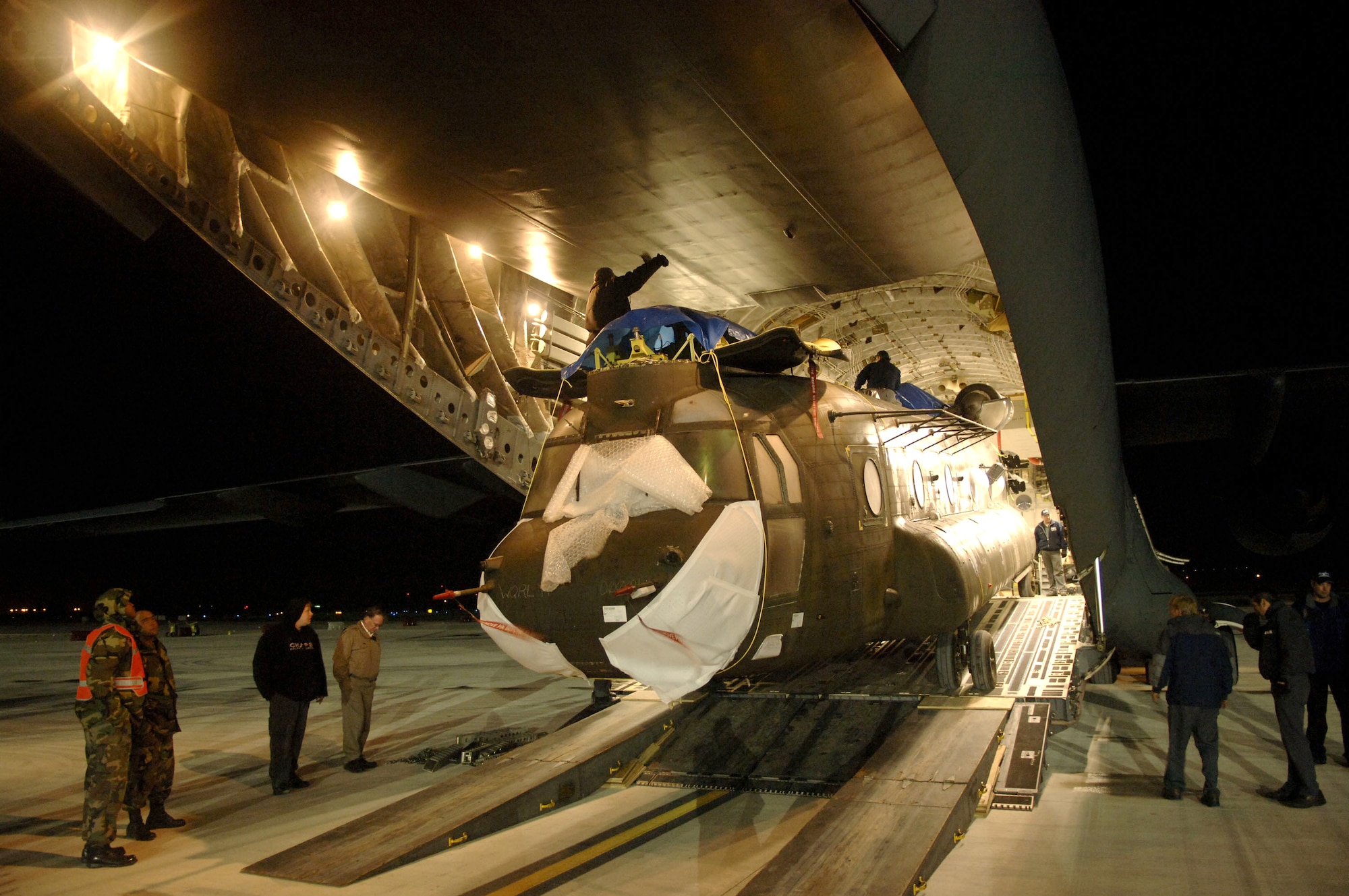 NAVAL STATION ROTA, Spain (AFPN) -- An Army CH-47 Chinook helicopter is loaded onto a C-17 Globemaster III Feb. 13. The Chinook was initially offloaded from the U.S.S. Pililaau here. (U.S. Air Force photo by Tech. Sgt. Russell E. Cooley IV)