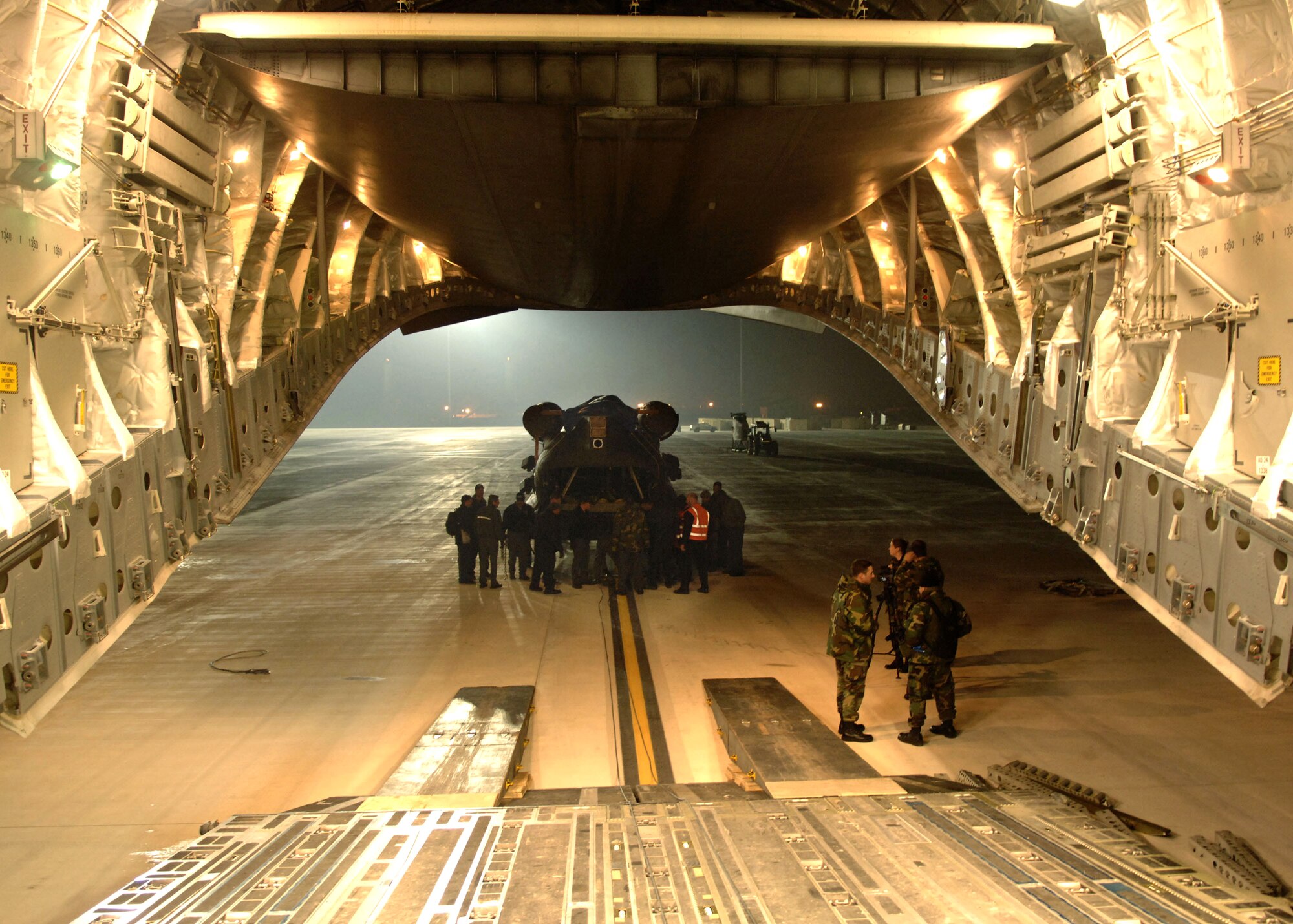 NAVAL STATION ROTA, Spain (AFPN) -- An Army CH-47 Chinook helicopter is loaded onto a C-17 Globemaster III Feb. 13. The Chinook was initially offloaded from the U.S.S. Pililaau here. (U.S. Air Force photo by Tech. Sgt. Russell E. Cooley IV)