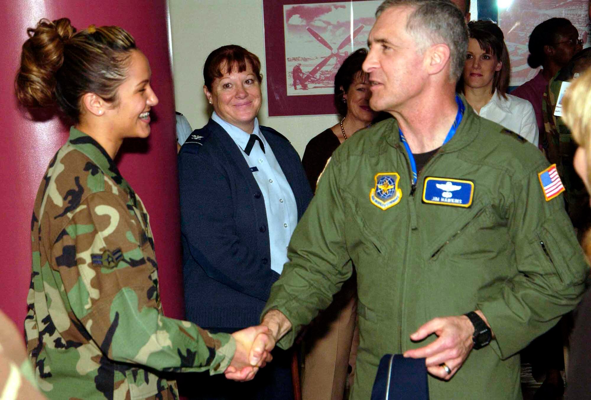 TRAVIS AIR FORCE BASE, Calif. (AMCNS) -- Airman 1st Class Jacklynn Levasseur, 60th Medical Diagnostics and Therapeutic Squadron, receives a coin from Maj. Gen. James A. Hawkins, 18th Air Force commander, Jan. 17. General Hawkins and his wife, Linda, met with Travis Airmen and community leaders during their one-day tour of the base. (Photo by Luther Tolliver)