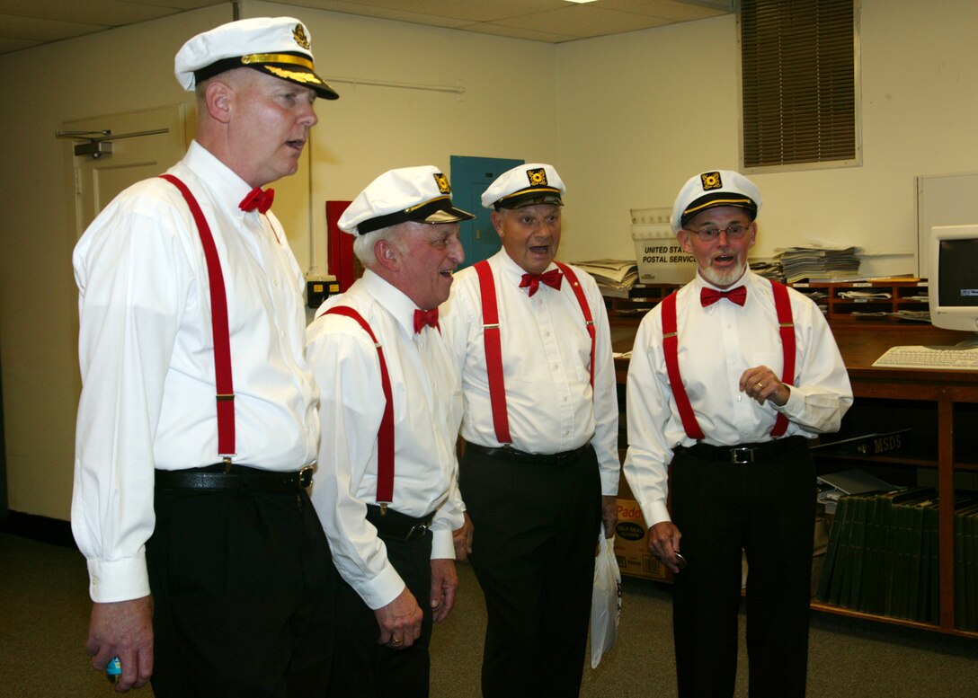 Colonel Joseph Wingard (Left), Depot installation logistics officer, sings along with the Harbormasters as they show off their talents aboard the Depot Feb. 13.