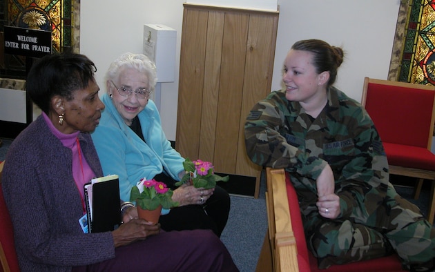 Staff Sgt. Claire Brom, 459th Financial Management, chats with a couple of veterans at the 459th Air Refueling Wing's Valentine's visit to the Armed Forces Retirement Home in Washington.  Sergeant Brom and several other members of the Air Force Reserve Command unit delivered warmth, laughter, cheer and goodies to the men and women of the AFRH.  The wing gave the veterans flowers, gifts and other goodies. The wing has adopted the AFRH as part of its family.