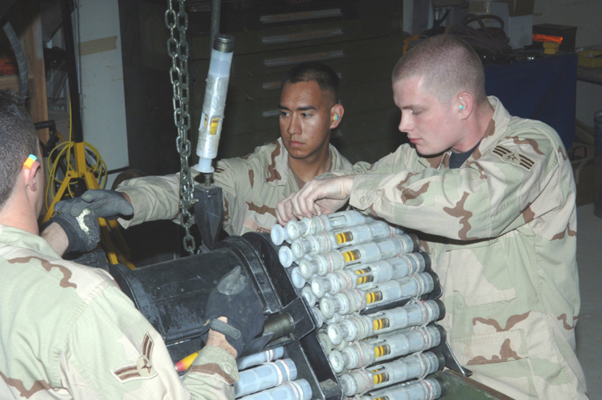 BAGRAM AIR BASE, Afghanistan (AFPN) -- Senior Airman Andrew Brown (right) and Airman 1st Class Jose Herrera process 30mm high-explosive incendiary ammunition. The Airmen are munitions systems journeyman with the 455th Expeditionary Maintenance Squadron, and are deployed from Eielson Air Force Base, Alaska. (U.S. Air Force photo Staff Sgt. Jennifer Redente)