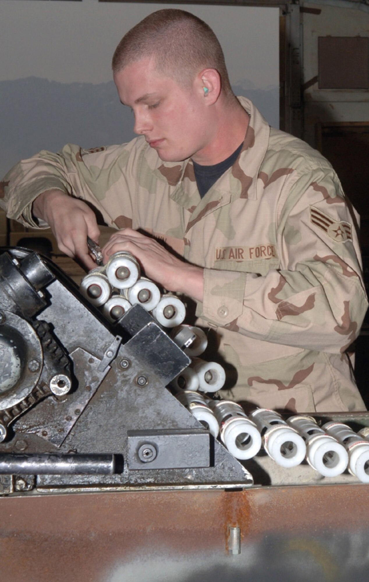 BAGRAM AIR BASE, Afghanistan (AFPN) -- Senior Airman Andrew Brown processes 30 mm high-explosive incendiary ammunition. Airman Brown is a munitions systems journeyman with the 455th Expeditionary Maintenance Squadron. He is deployed from Eielson Air Force Base, Alaska. (U.S. Air Force photo by Staff Sgt. Jennifer Redente)