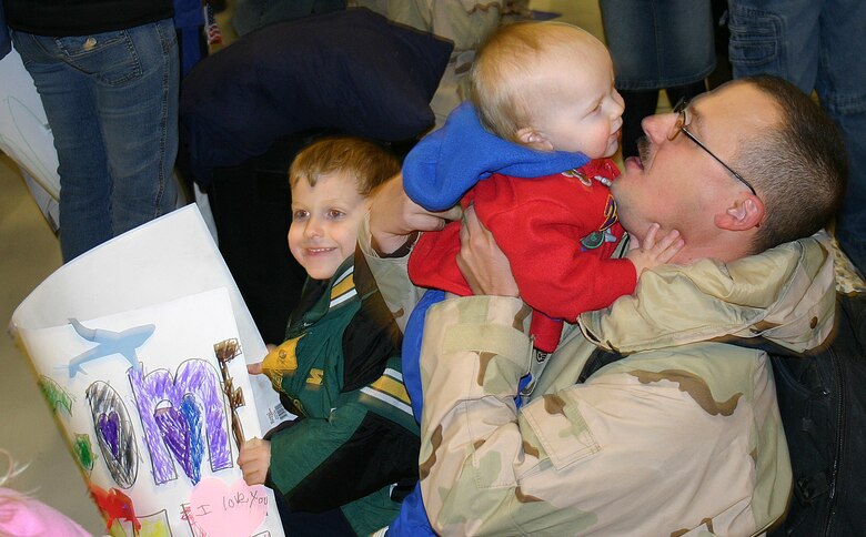 CANNON AIR FORCE BASE, N.M.--Staff. Sgt. Anthony J. Ashbeck, 27th Civil Engineer Squadron, returns home Jan. 25 to see his two sons Andrew (left) and Camden. Sergeant Ashbeck was deployed to Southwest Asia along with 500 other Airmen from the 27th CES. (U.S. Air Force photo by Airman Thomas R. Trower)