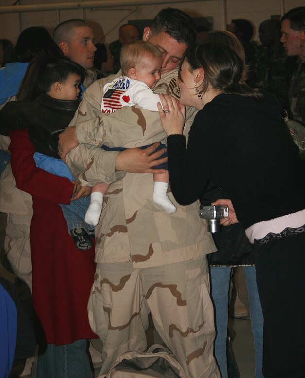 CANNON AIR FORCE BASE, N.M. -- Staff Sgt. Ryan Dobbel, 27th Civil Engineer Squadron, returns home to his wife, Jessica, and their 7-month-old daughter Taylor after a four-month tour in Southwest Asia. Over 100 27th Fighter Wing Airmen returned to Cannon Jan. 25. (U.S. Air Force photo by Airman Thomas Trower)