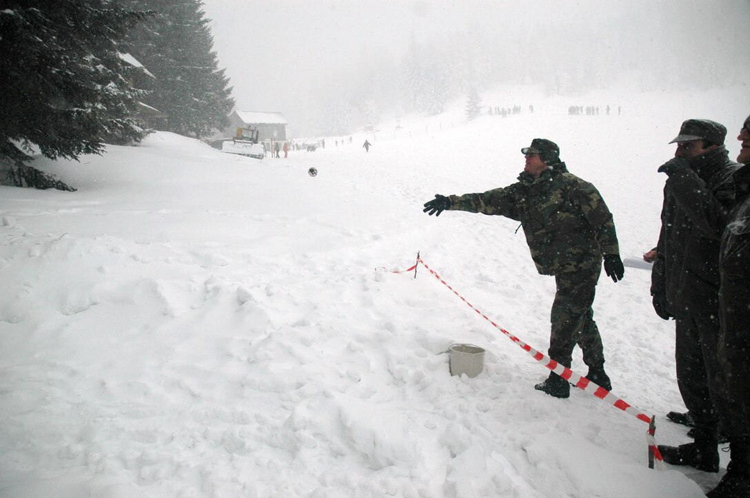 TUZLA AIR BASE, Bosnia and Herzegovina (AFPN) -- Lt. Col. David Lowe throws a dummy hand grenade during Operation Winter Games. Colonel Lowe is commander of Detachment 1, 401st Air Expeditionary Wing.(U.S. Air Force photo by Master Sgt. Chance Babin) 