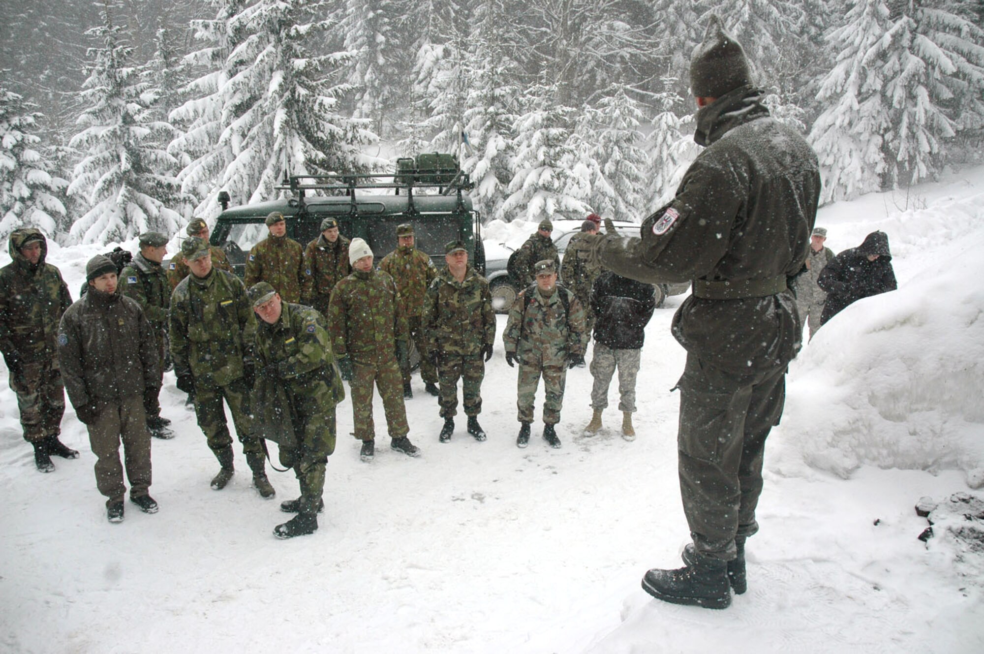 TUZLA AIR BASE, Bosnia and Herzegovina (AFPN) -- Operation Winter games participants receive a pregame briefing from the Austrian contingency that hosted the games here. The three-man Air Force team competed against 12 other teams from 14 nations. (U.S. Air Force photo by Master Sgt. Chance Babin) 
