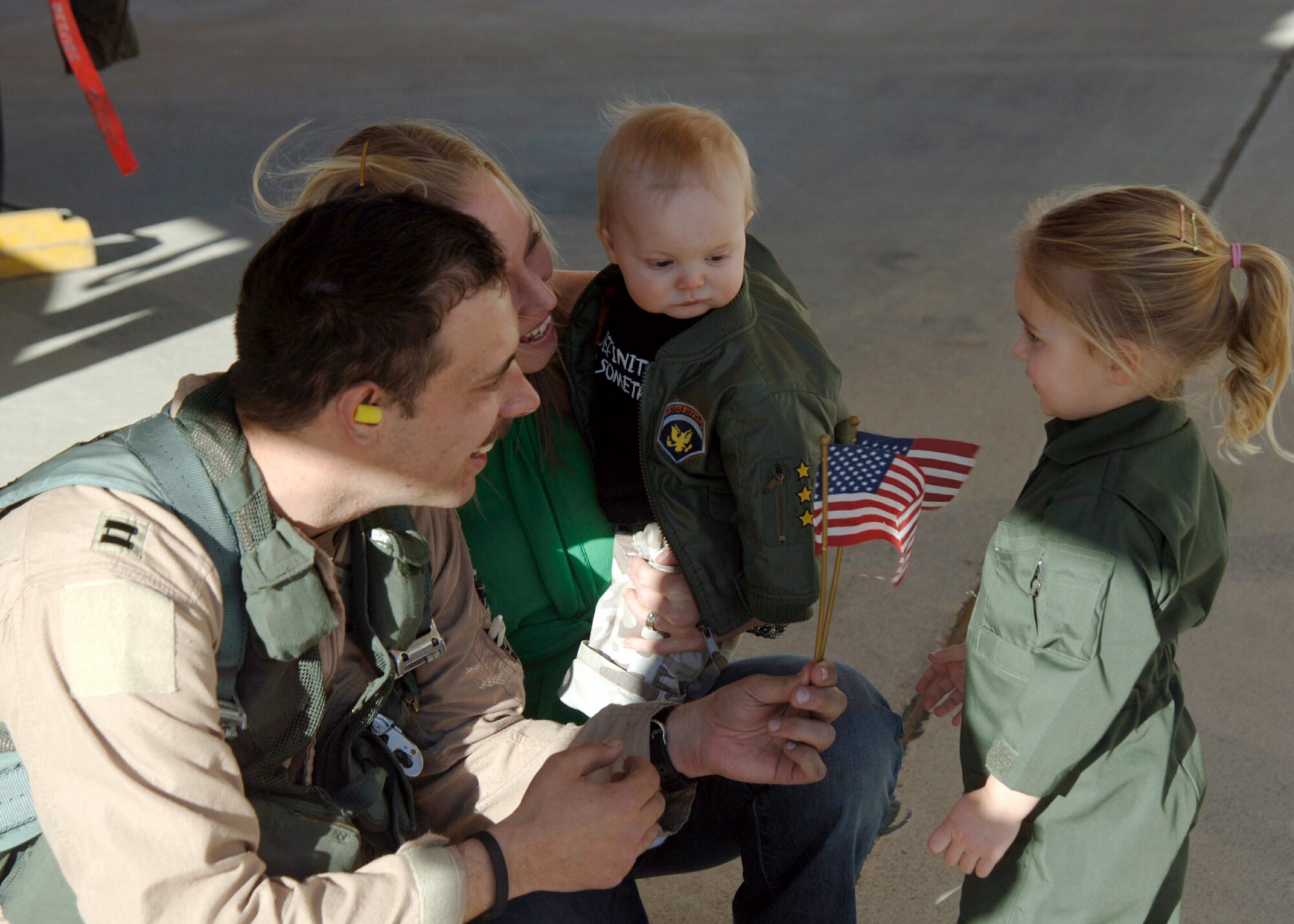 DAVIS-MONTHAN AIR FORCE BASE, Ariz. (AFPN) -- Capt. Jay Annis reunites with his family upon his return home Feb. 10. Captain Annis, an A-10 Thunderbolt II pilot with the 354th Fighter Squadron, was deployed to Bagram Air Base, Afghanistan, in support of Operation Enduring Freedom. (U.S Air Force photo by Airman 1st Class Christina D. Ponte)