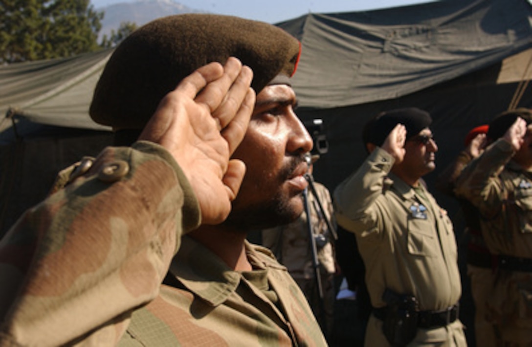 Pakistan army soldiers with the Pakistan 67th Medical Battalion salute during a transfer of authority ceremony with U.S. Army soldiers of the 212th Mobile Army Surgical Hospital in Muzaffarabad, Pakistan, on Feb. 16, 2006. The Pakistan Medical Battalion will provide medical treatment to victims of the devastating earthquake that struck the region Oct. 8, 2005. 