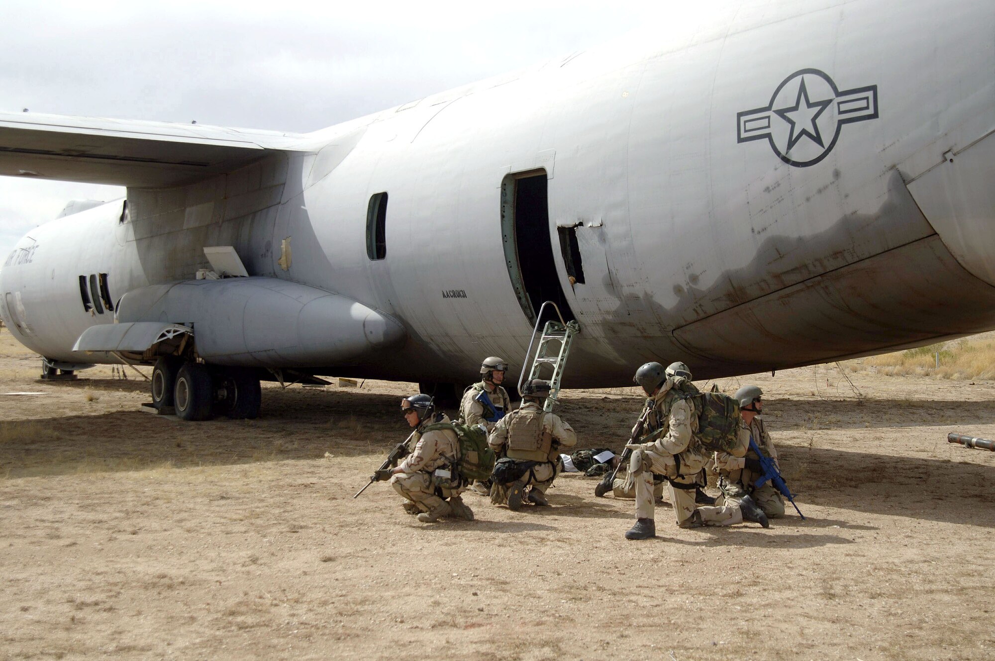 DAVIS-MONTHAN AIR FORCE BASE, Ariz. (AFPN) -- Pararescuemen and members of the Dutch Army, rally near a C-141 Starlifter before searching for casualties during a joint mass casualty exercise Feb. 14. The scenario involved a simulated shoot-down of the cargo plane by a missile. The pararescuemen are with the 48th Rescue Squadron. (U.S. Air Force photo by Airman 1st Class Christina D. Ponte)