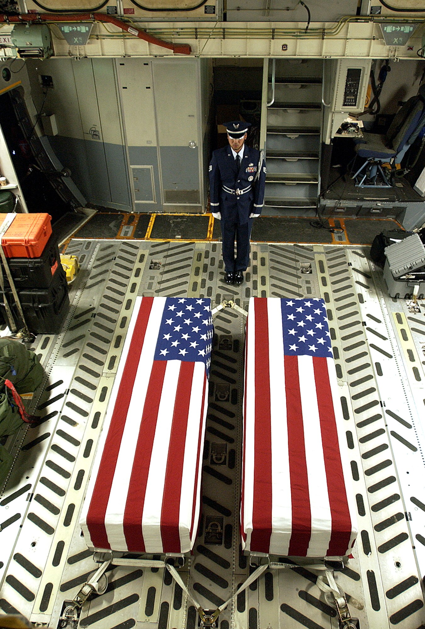 ANDERSEN AIR FORCE BASE, Guam (AFPN) -- Staff Sgt. Gilbert Anacleto, 734th Air Mobility Squadron, stands guard over two fallen American servicemembers from the Vietnam War whose remains are on their way to Hawaii for identification.  Sergeant Anacleto is a member of the Blue Knights Honor Guard. (U.S. Air Force photo by Airman Michael S. Dorus)

