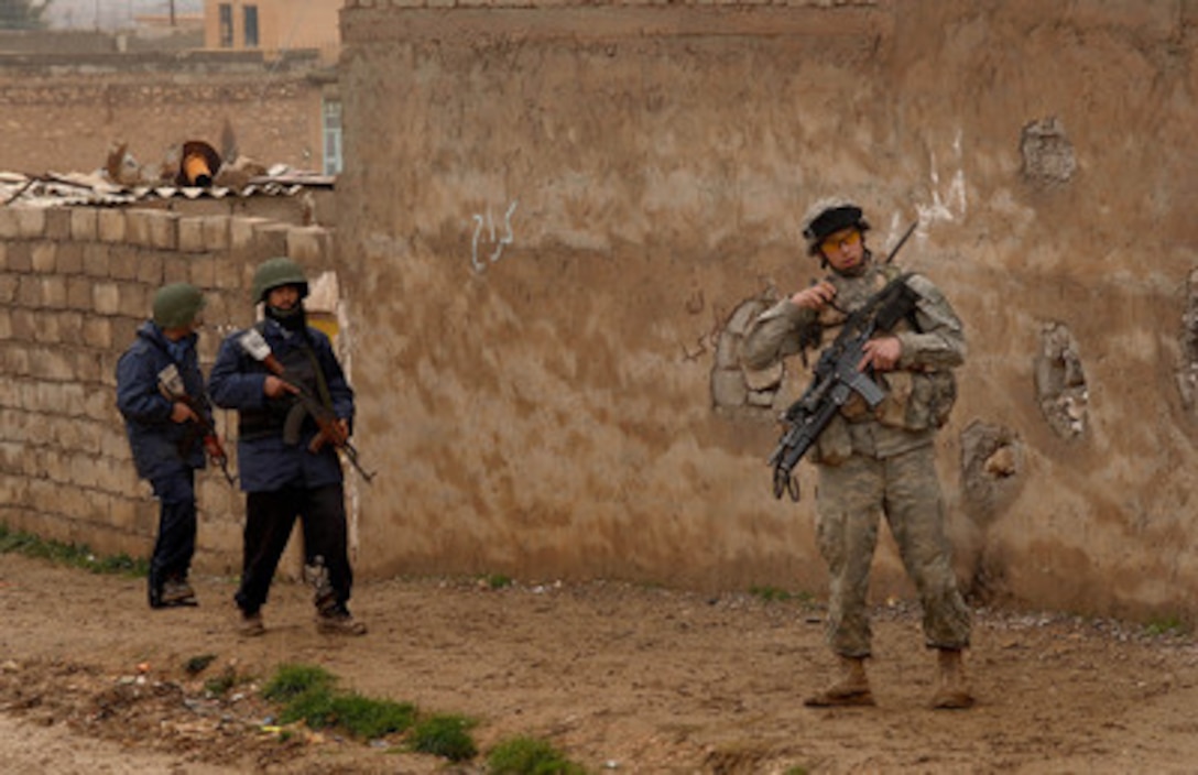 U.S. Army Sgt. Daniel Wert and Iraqi policemen patrol the streets of Tall Afar, Iraq, on Feb. 14, 2006. Wert is attached to the1st Armored Division. 