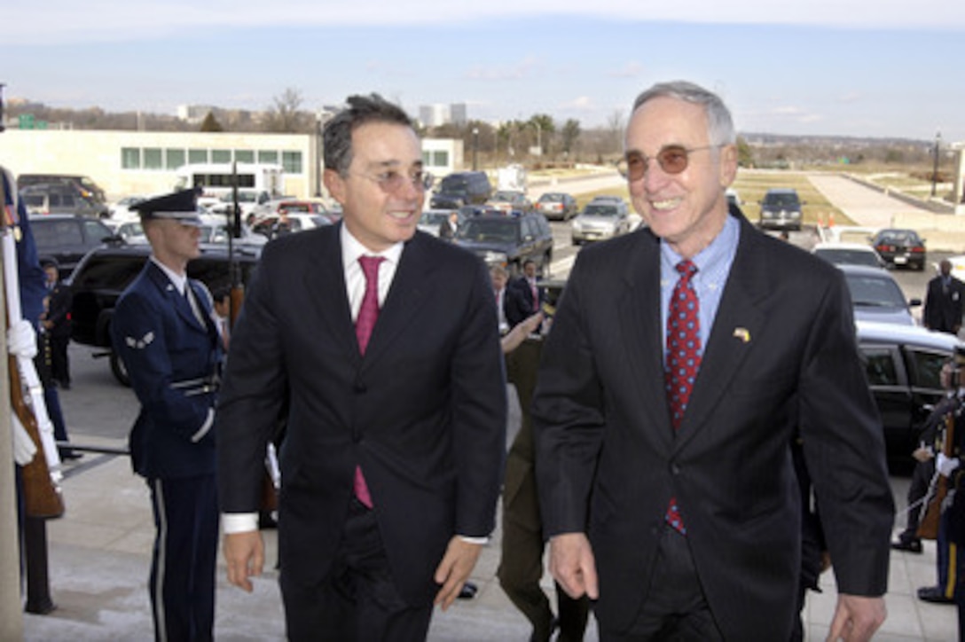 Colombian President Alvaro Uribe (left) is escorted by Deputy Secretary of Defense Gordon England (right) through an honor cordon and into the Pentagon on Feb. 17, 2006. 