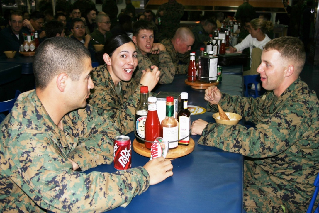 It's not Baskin Robins but that's  OK with the Marines from the 11th MEU?s communications section (from left) Sgt. John P. Garcia, radio maintenance technician, Sgt. Marlena K. Helm, field wireman and Sgt. Matthew D. Herring, network administrator. The Marine communicators enjoy a cold one, ice cream that is, during an ice cream social aboard the USS Peleliu Feb. 17.