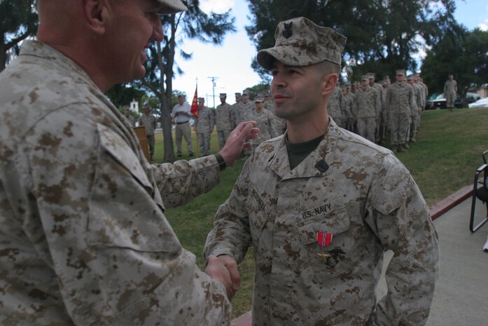 060217-M-7082F-001 MARINE CORPS BASE CAMP PENDLETON, Calif -- Major Gen. Richard F. Natonski congratulates Petty Officer 1st Class Nathan McDonell after awarding him the Bronze Star here Feb. 17. McDonell was recognized for saving the life of Cpl. Mark O'Brien Nov. 8, 2004 in the midst of a firefight in Ramadi. McDonell was the senior line corpsman for Company G, 2nd Battalion, 5th Marine Regiment, 1st Marine Division. Natonski is the commanding general of the 1st Marine Division. (Official U.S. Marine Corps photo by Lance Cpl. Patrick J. Floto)(released)