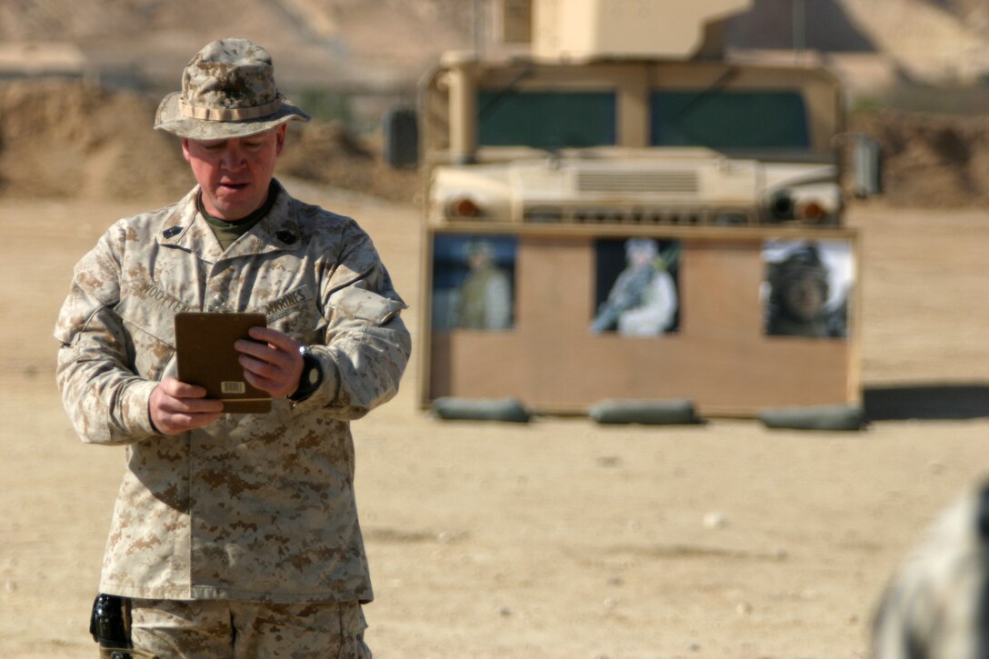 Charlie Company 1st Sgt. Michael Wooten conducts roll call during a memorial service held in honor of Cpl. Orville Gerena, Lance Cpl. David Parr, and PFC Jacob Spann at Al Asad Air Base, Iraq Feb. 18, 2006.  The three Charlie Company Marines were killed conducting counterinsurgency operations in Iraq's Al Anbar province.