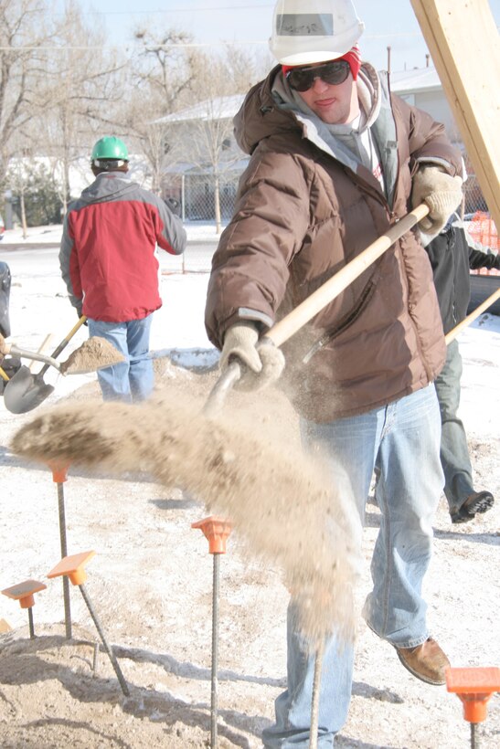 George Foelsch, poolee from RSS Metro South, levels the ground by shoveling dirt February 18, for Habitat for Humanity of Denver.